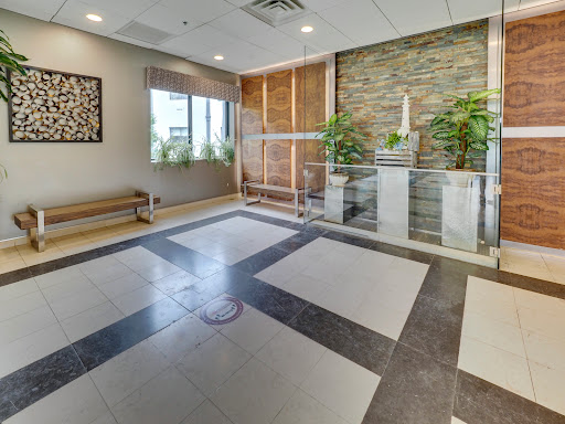 A contemporary lobby featuring a blend of natural elements and modern design.