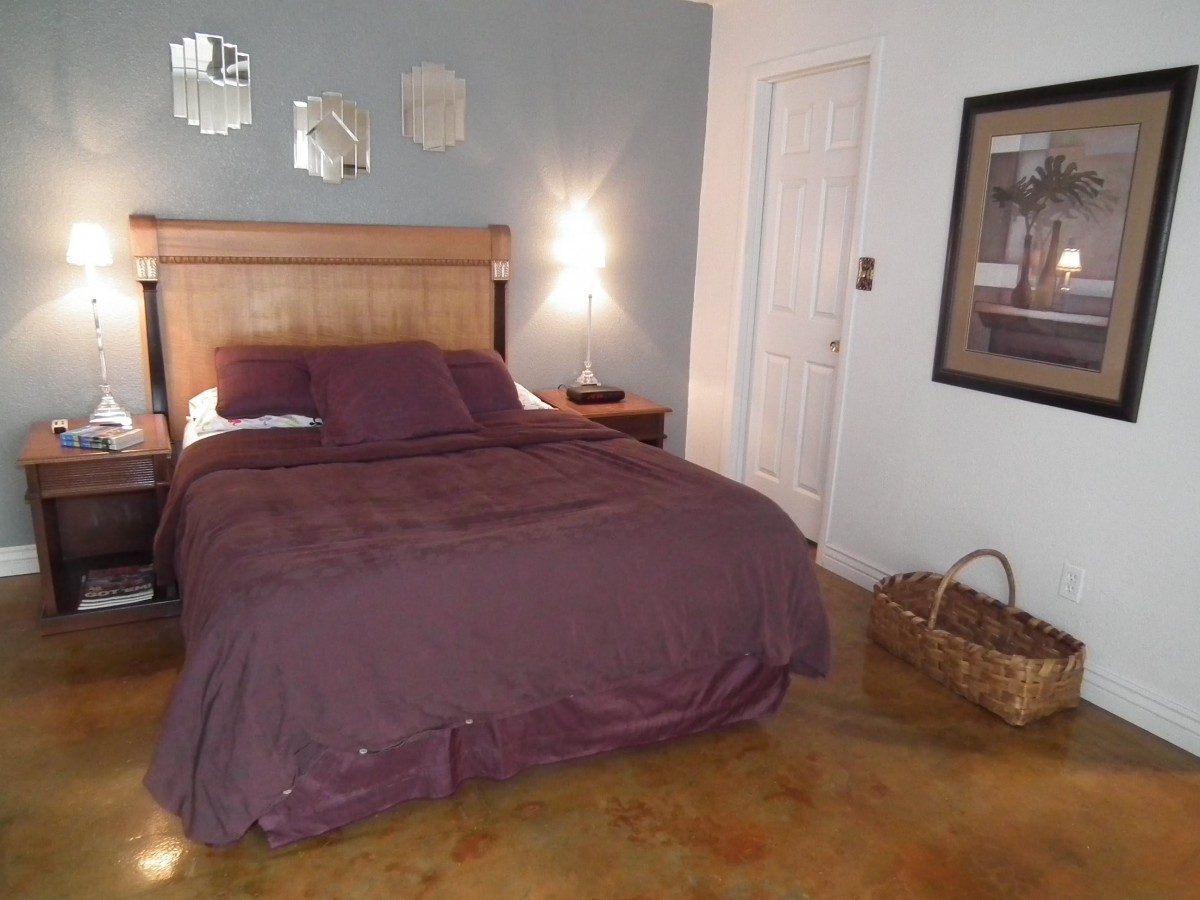 A cozy bedroom with a neatly made bed and a warm ambiance.