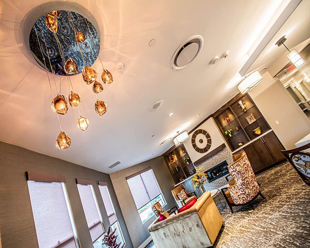 A modern living room with stylish lighting and elegant furnishings.