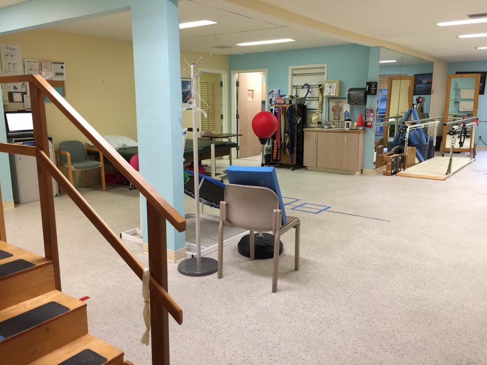 A rehabilitation center equipped with various physical therapy tools and exercise equipment.