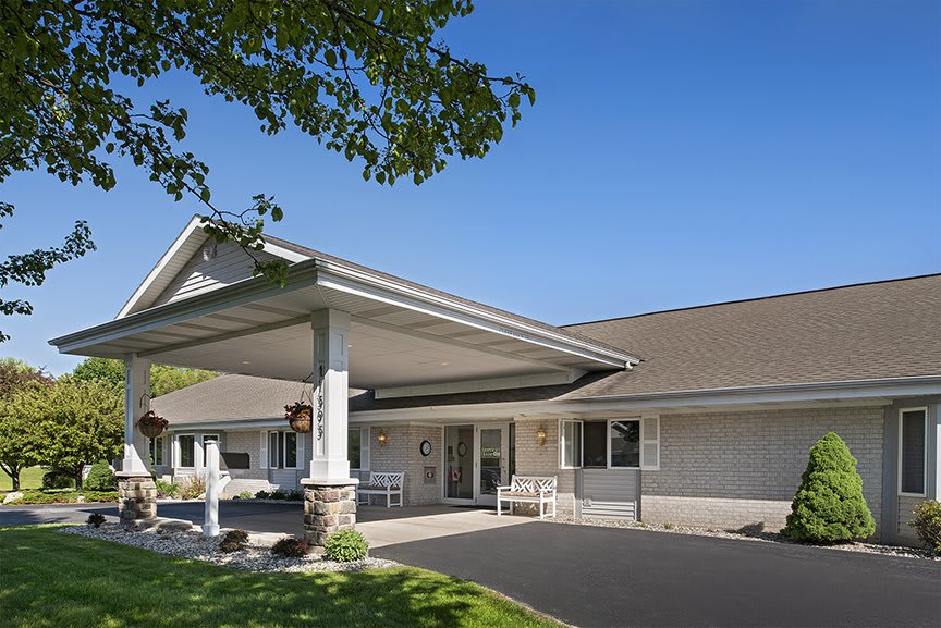 A well-maintained building entrance with a covered driveway.