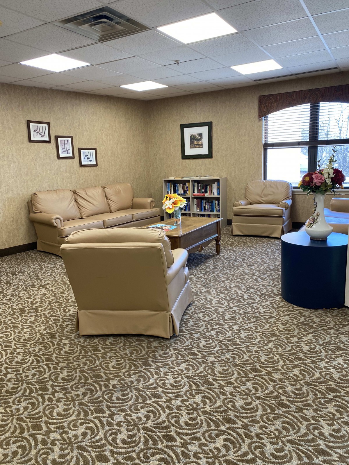 A cozy living room with comfortable seating and floral decorations.