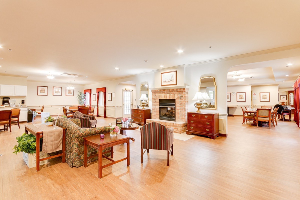 A spacious and cozy living room with elegant furnishings and a fireplace.