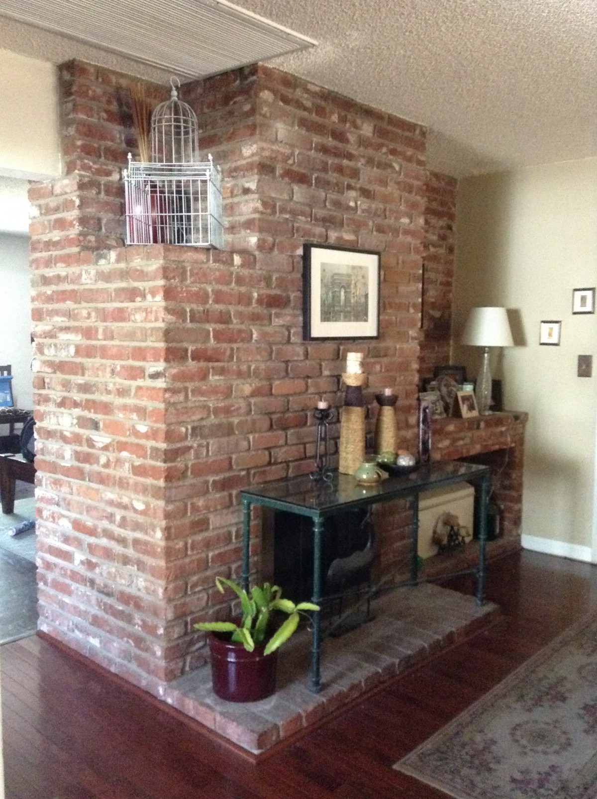 A cozy living room with an exposed brick wall and eclectic decor.