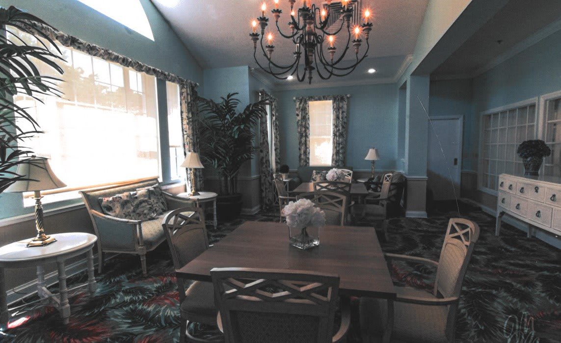 A cozy living room interior with elegant furniture and a chandelier.