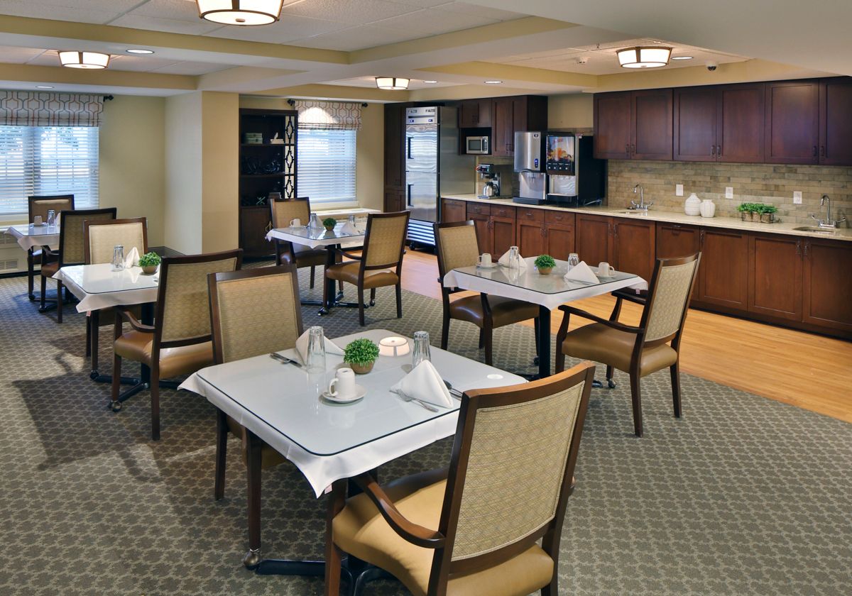 A well-arranged dining area with neatly set tables and comfortable chairs.