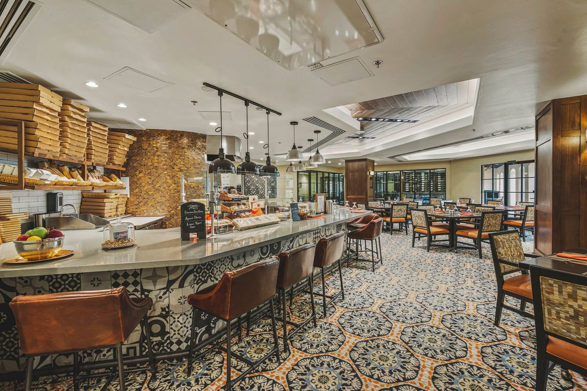 A stylish restaurant interior with a bar and seating area.