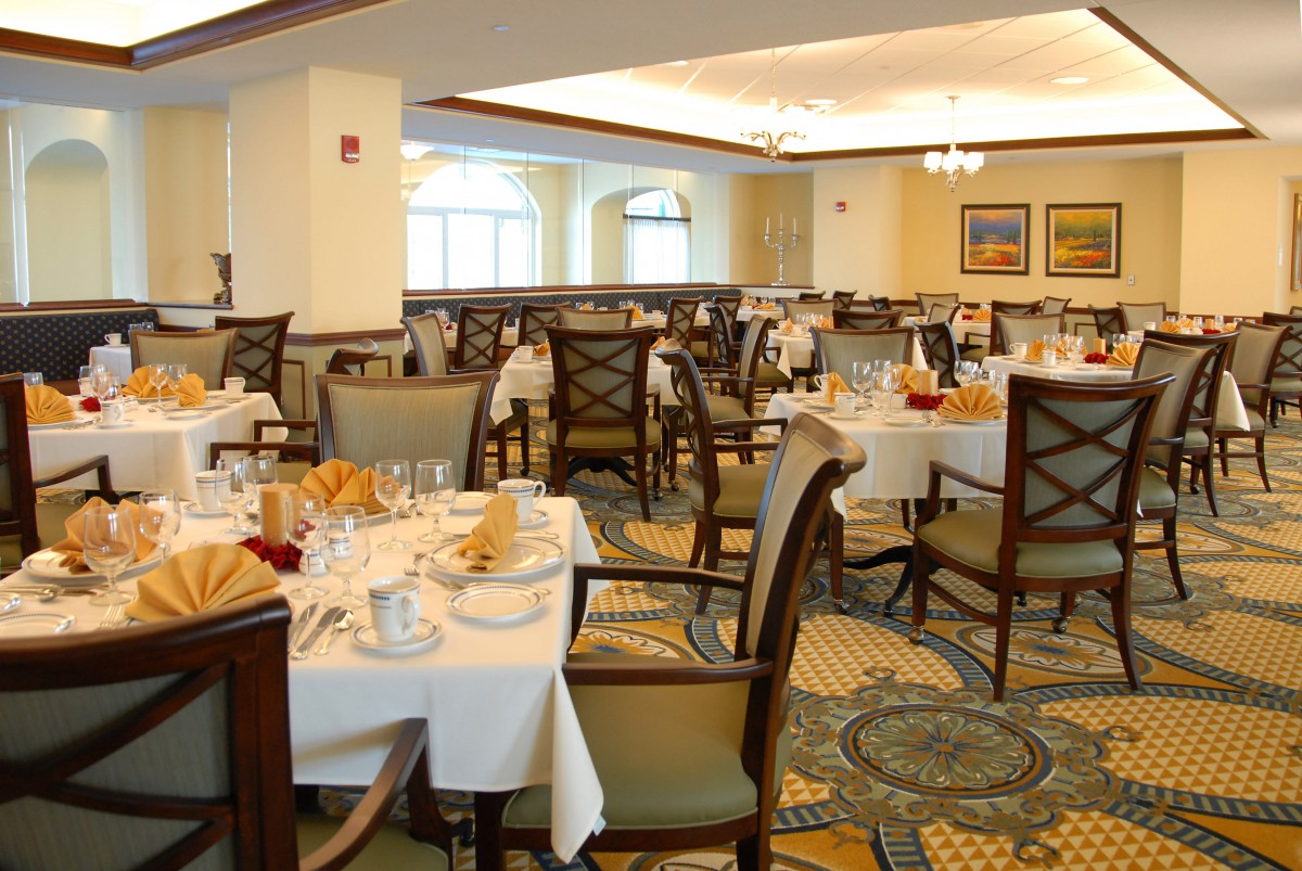 An elegant dining area with neatly set tables and chairs, prepared for guests.