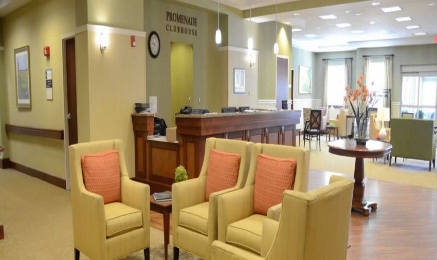 A well-lit lobby with comfortable seating and a reception desk.