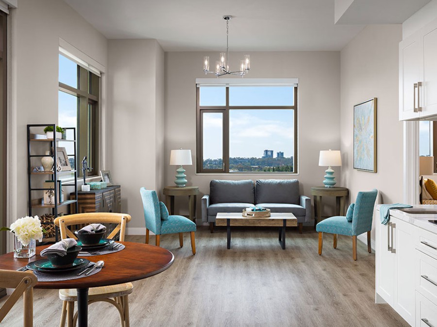 A modern living room with stylish furnishings and a scenic city view.