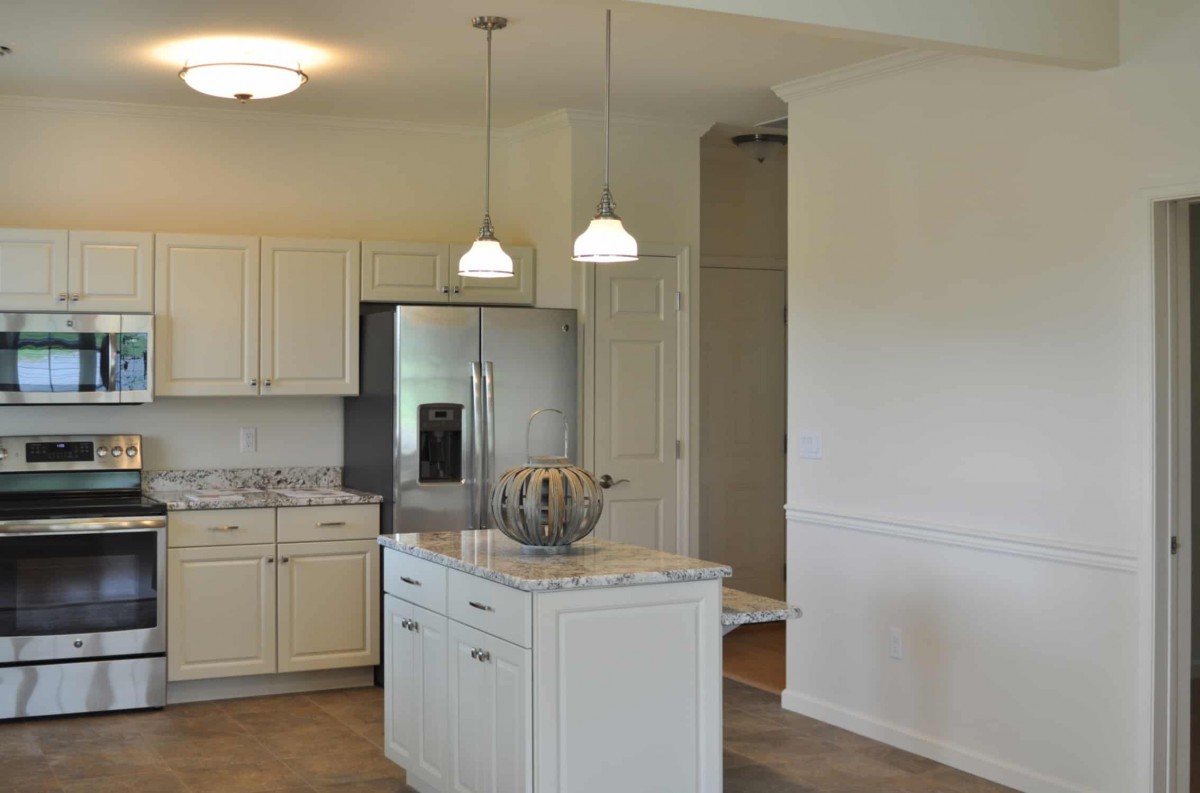 Modern kitchen with white cabinets and a central island.