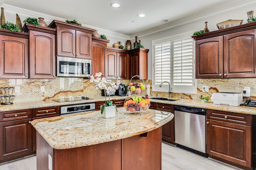 A beautifully designed modern kitchen featuring rich wood cabinetry, granite countertops, and ample natural light.