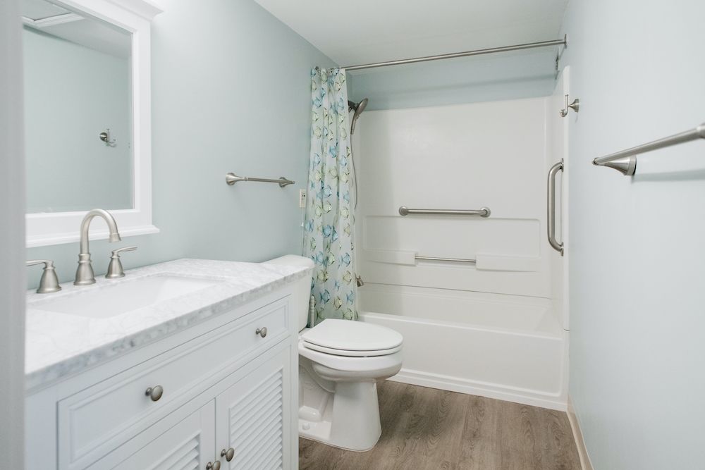 A modern bathroom with a shower and vanity.