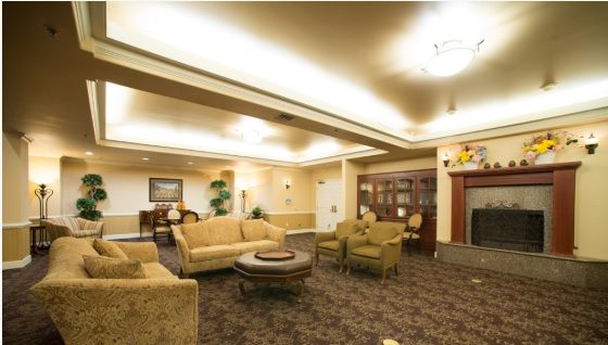 A spacious living room with comfortable seating and elegant lighting.
