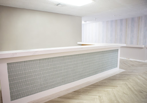 A sleek and modern reception desk in a minimalist office environment.