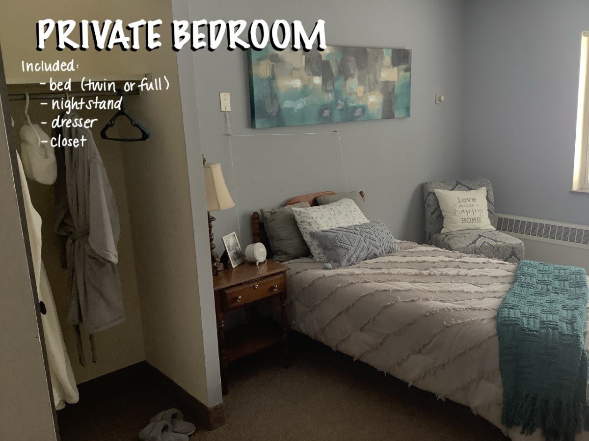 A cozy private bedroom with a neatly made bed, bedside table, and soft lighting.