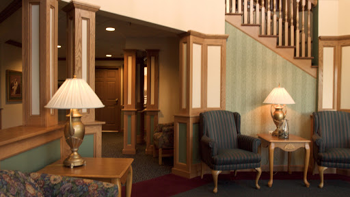 A cozy lobby area featuring comfortable seating, elegant wooden details, and warm lighting.