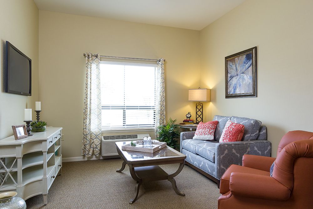 A cozy living room with a sofa, coffee table, and elegant decor.