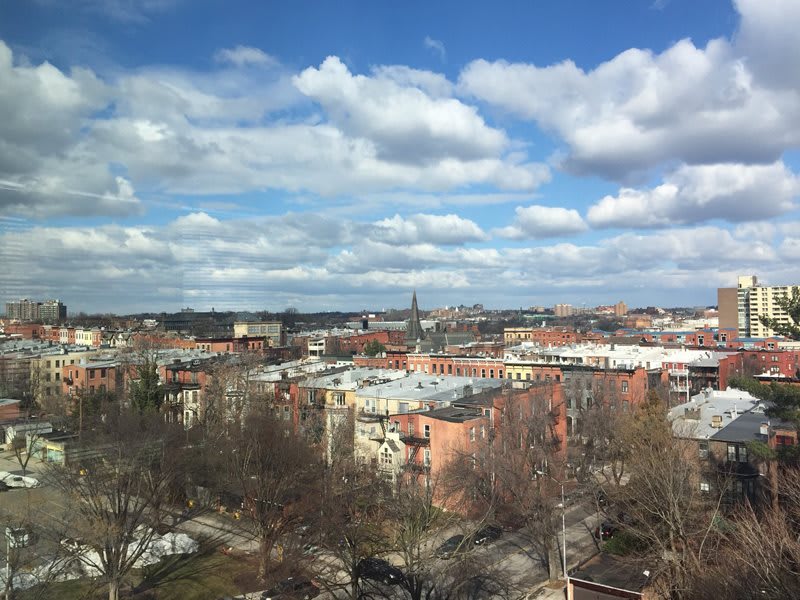 A scenic view of a cityscape under a partly cloudy sky.