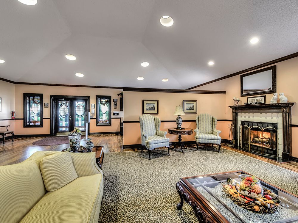 A cozy living room with elegant furniture and a warm fireplace.