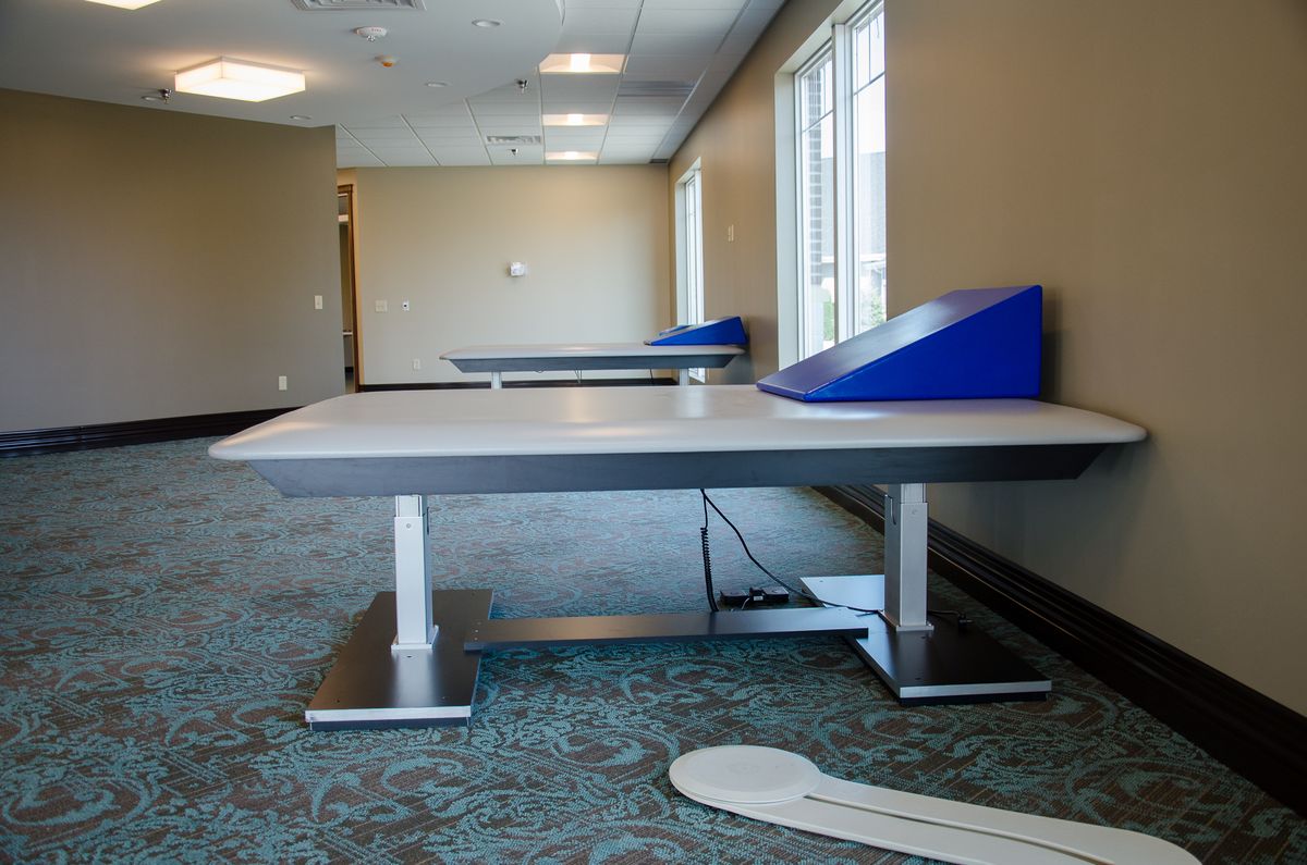 A therapy room with specialized tables and medical equipment.