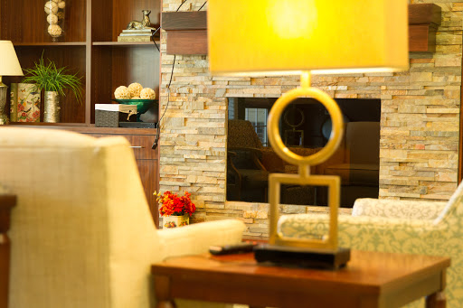 A stylish living room featuring a modern decorative sculpture, warm lighting, and a cozy ambiance.