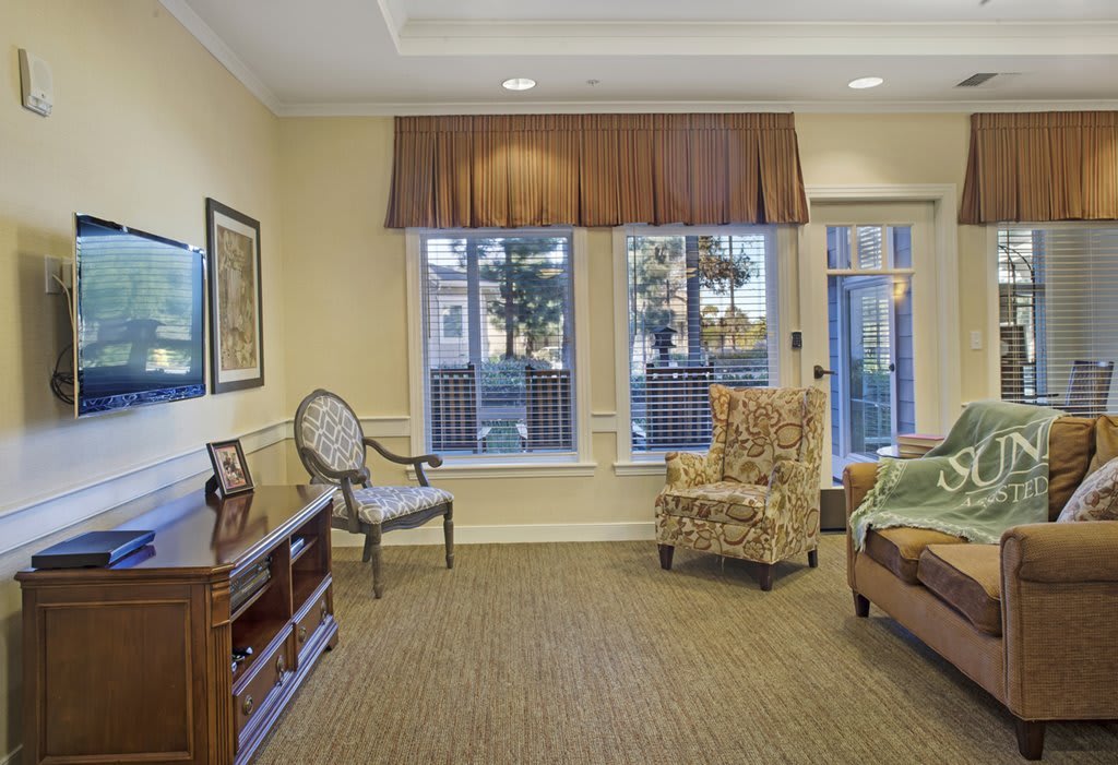 A cozy living room with comfortable seating and large windows allowing natural light.