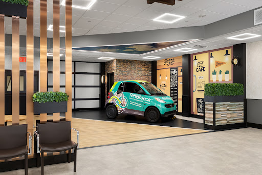 A vibrant and modern interior showcasing a decorated car in a lobby-like environment.