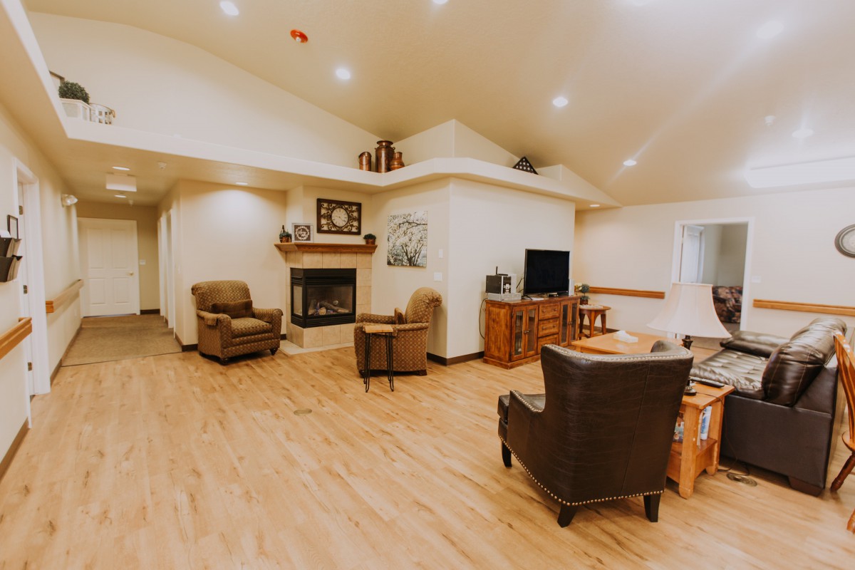 A cozy living room with comfortable seating, a fireplace, and a television.