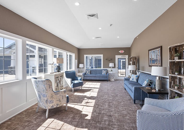 A bright living room with modern furniture and large windows.