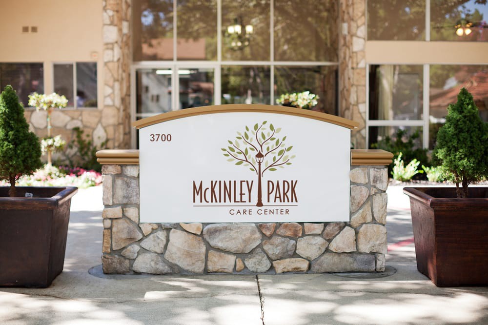 A stone sign with 'McKinley Park' displayed at the entrance of a building.