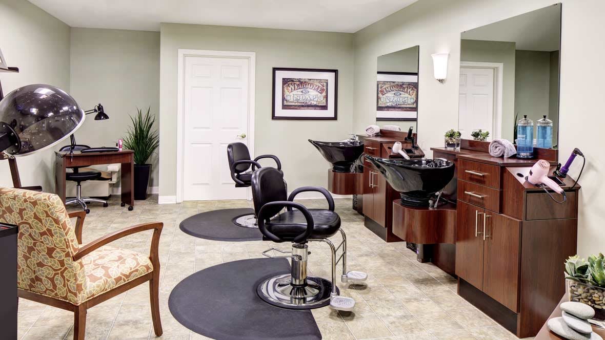 A modern hair salon interior with chairs and mirrors.