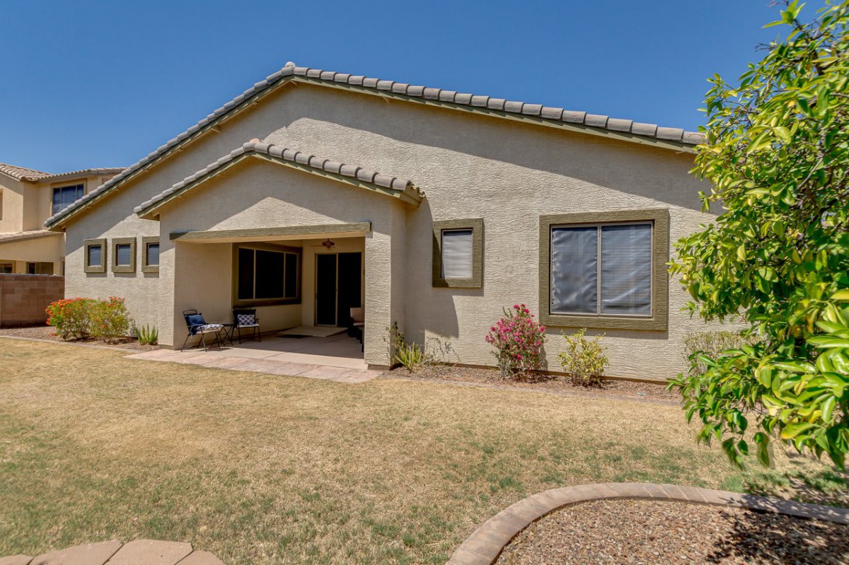 A single-story house with a small front yard featuring desert landscaping.