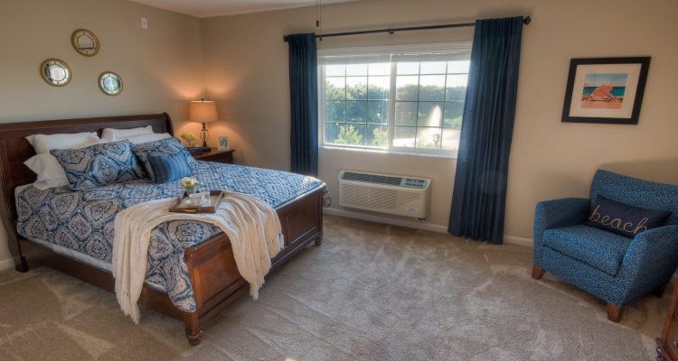 A cozy bedroom with a large window and elegant decor.
