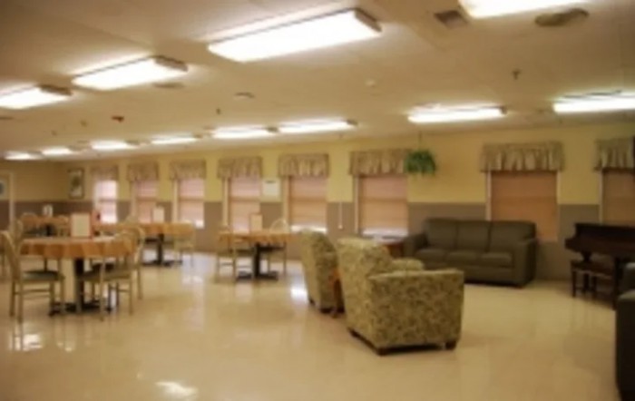 A spacious indoor lounge with comfortable seating and tables.