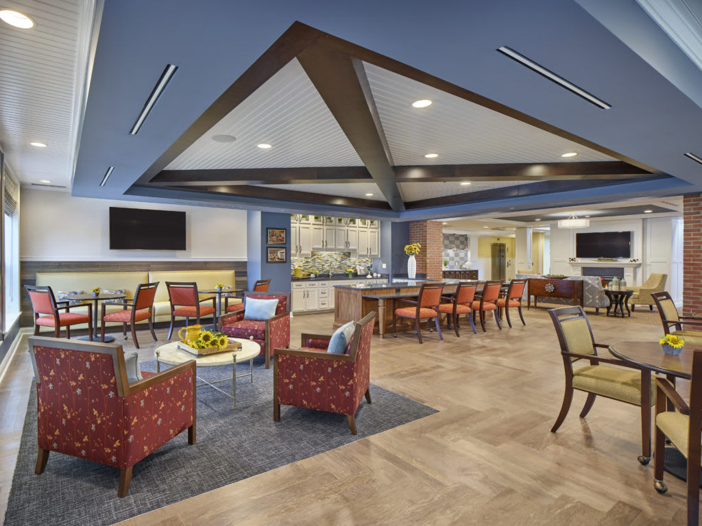 A modern lounge area with various seating arrangements and vibrant decor.