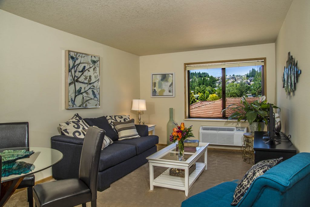 A cozy living room with stylish decor and a view of the outdoors.
