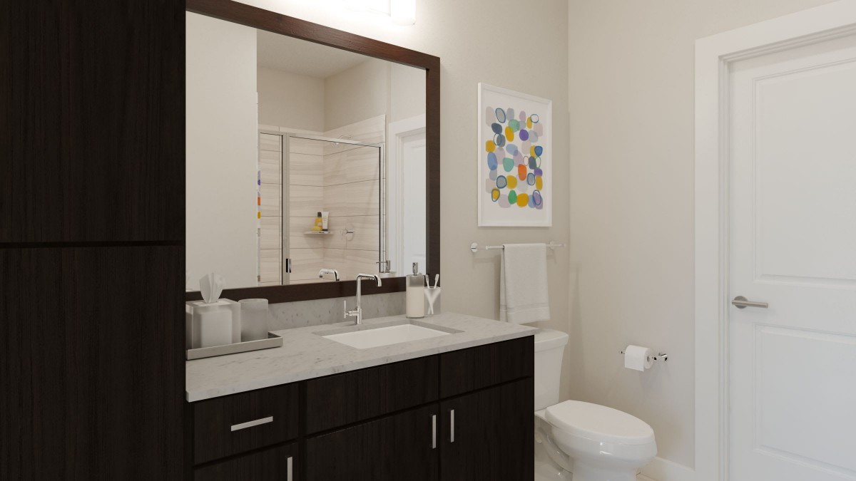A modern bathroom with a large mirror, sink, and toilet, featuring colorful artwork on the wall.
