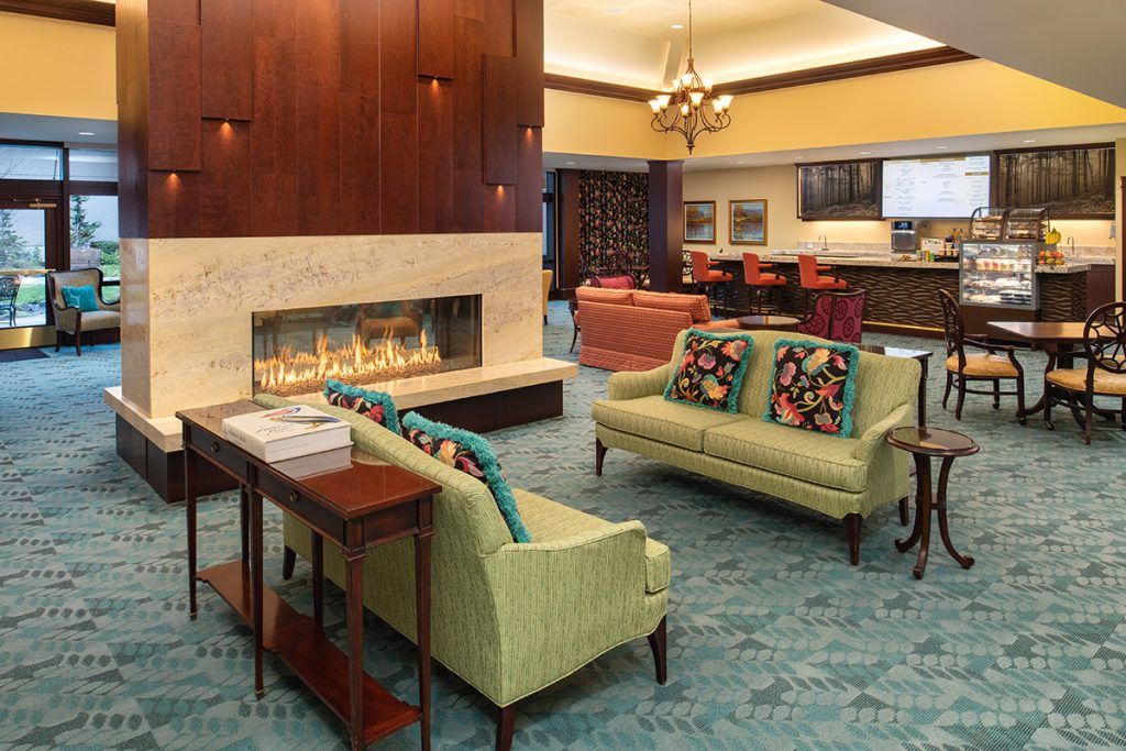 A cozy hotel lobby with elegant seating and a fireplace.