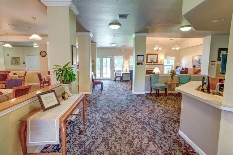 A cozy lobby area with plush carpeting, comfortable seating, and soft lighting.