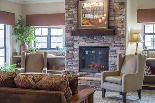 A cozy living room featuring a modern fireplace and stylish seating.