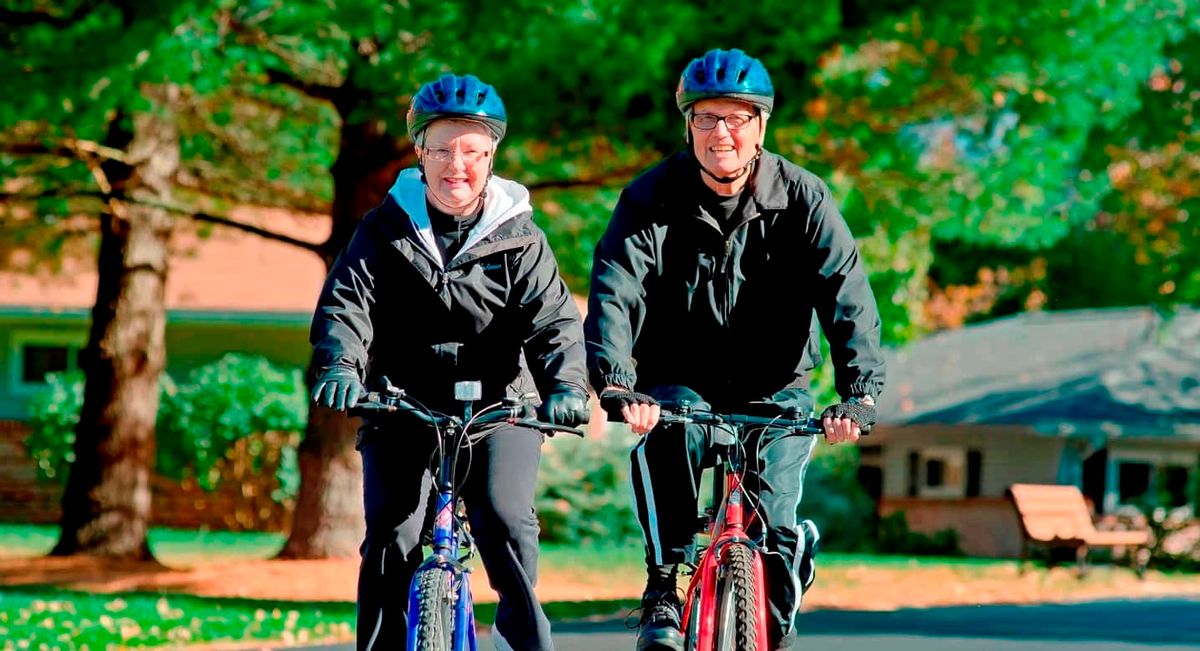 Two people enjoying a bike ride outdoors.