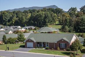 A suburban house with a mountainous landscape in the background.