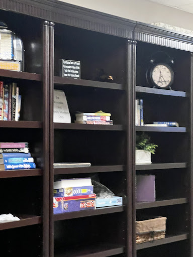 A neatly organized bookshelf featuring a mix of books and decorative items.
