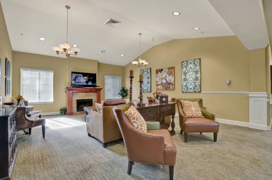 A cozy living room with comfortable seating, a fireplace, and a television.