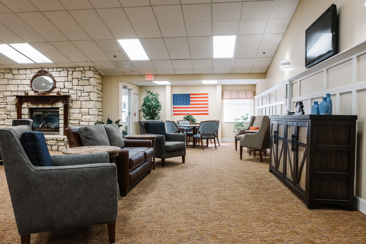 A cozy living room with sofas, chairs, and an American flag decoration.
