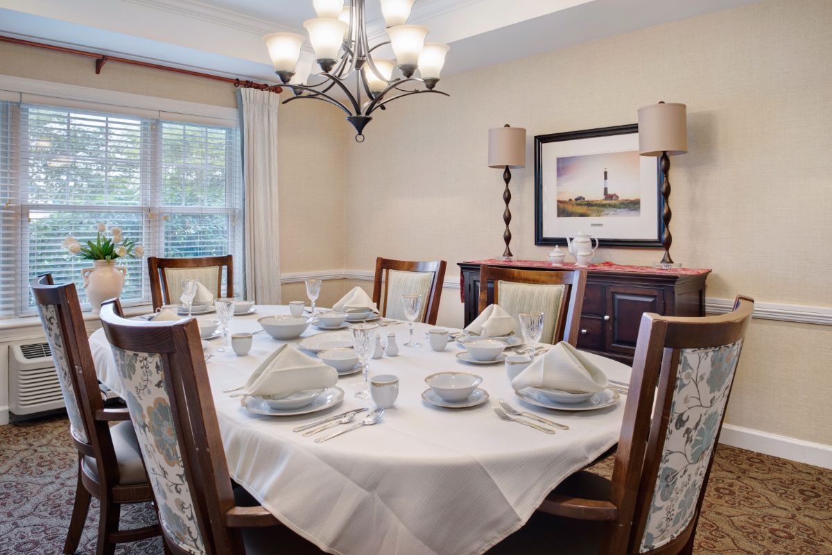 A beautifully set dining table with elegant decor and a chandelier.