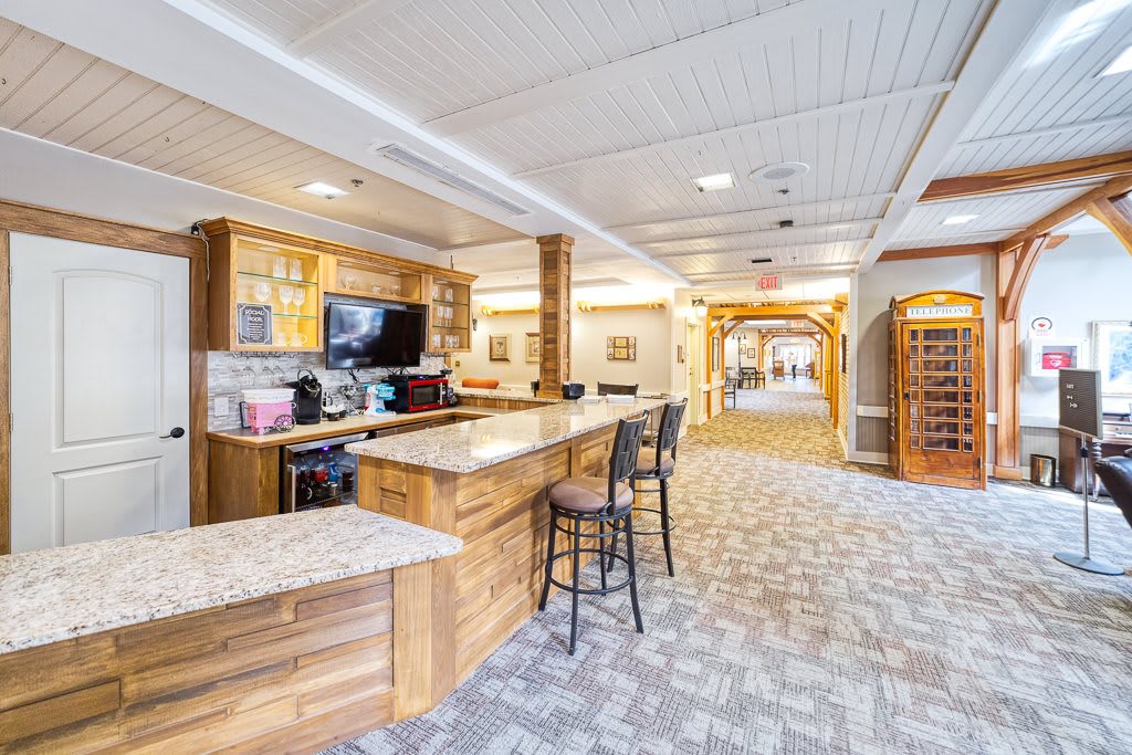 A bright and inviting lobby with a wooden bar area and seating.