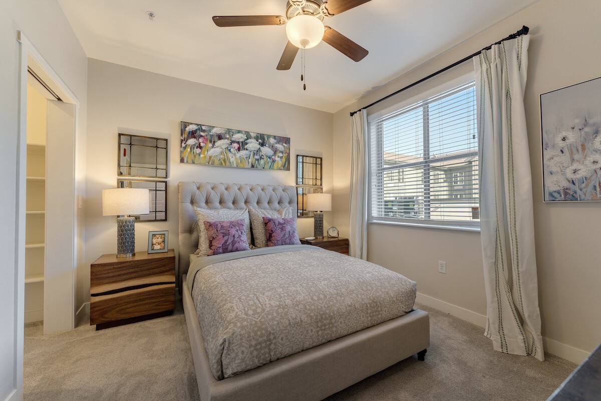A cozy bedroom with a neatly made bed, soft lighting, and modern decor.