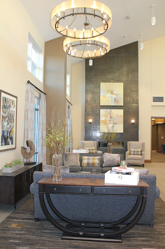 A modern lounge area featuring stylish furniture, decorative elements, and contemporary artwork.
